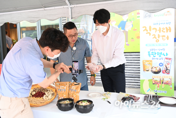 산림조합이 초복을 맞아 7일 오후 서울 송파구 산림조합중앙회 앞에서 임산물 소비 촉진행사 우리 숲에서 자란 직거래 장터-초복맞이 삼계탕 특판행사 라이브 쇼핑 행사를 개최했다. 쇼호스트로 나선 개그맨 송영길과 정현우 올계 마케팅부 사원이 제품을 소개하고 있다.