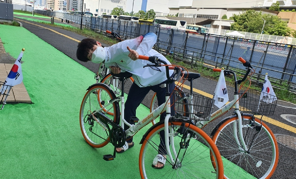 재일본대한체육회가 도쿄올림픽에 참가한 한국 선수단을 위해 기증한 자전거에 친필 사인을 남기고 기념 촬영을 한 이다빈(태권도). [사진=대한체육회]