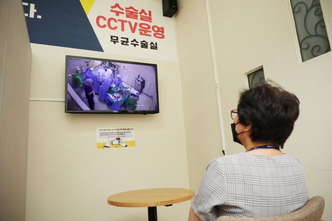 환자 보호자가 수술실 CCTV를 통해 실시간 수술 상황을 지켜보고 있다.  [사진=힘찬병원]