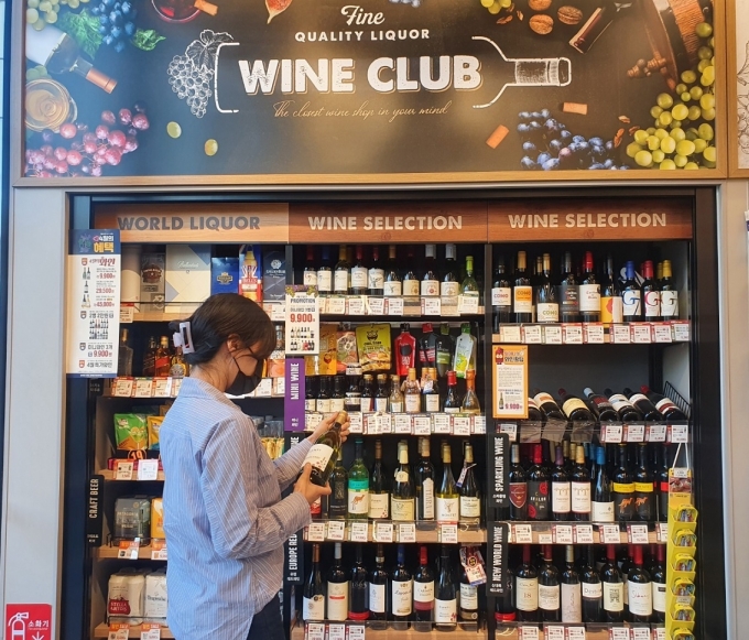 한 고객이 이마트24 주류특화매장에서 와인을 살펴보고 있다. [사진=이마트24]